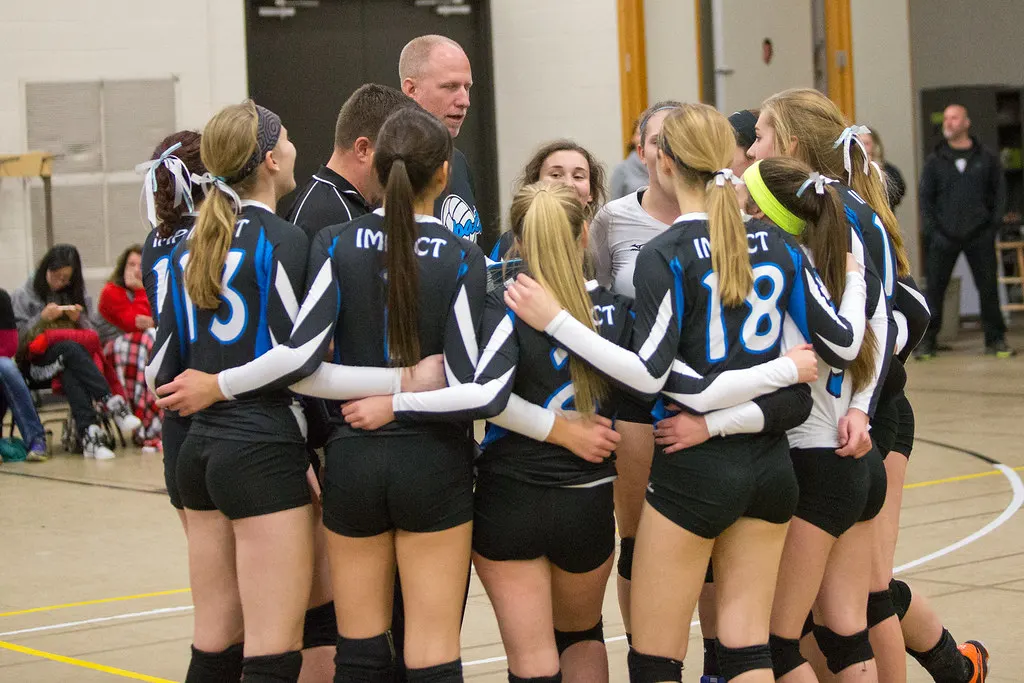 Youth soccer team gathered in a huddle